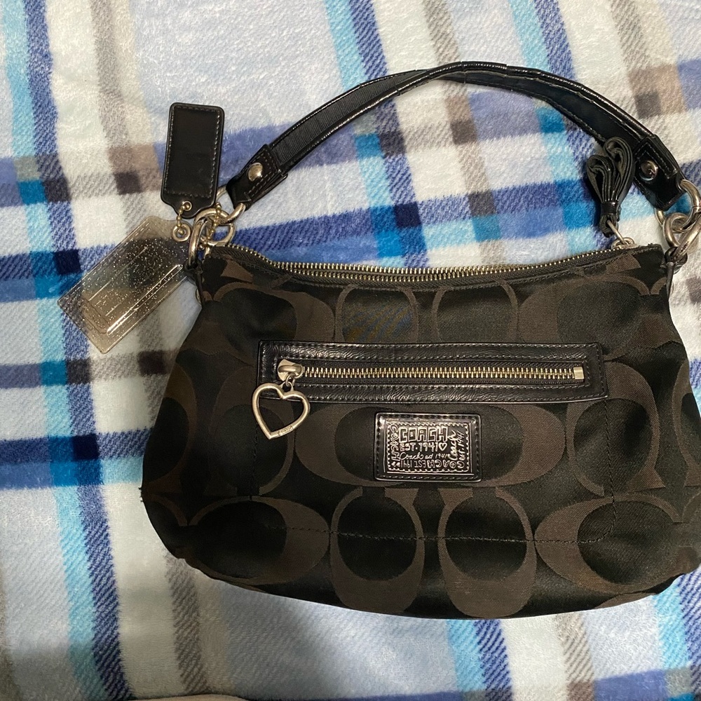 This is a mini black Block C pattern Coach purse.